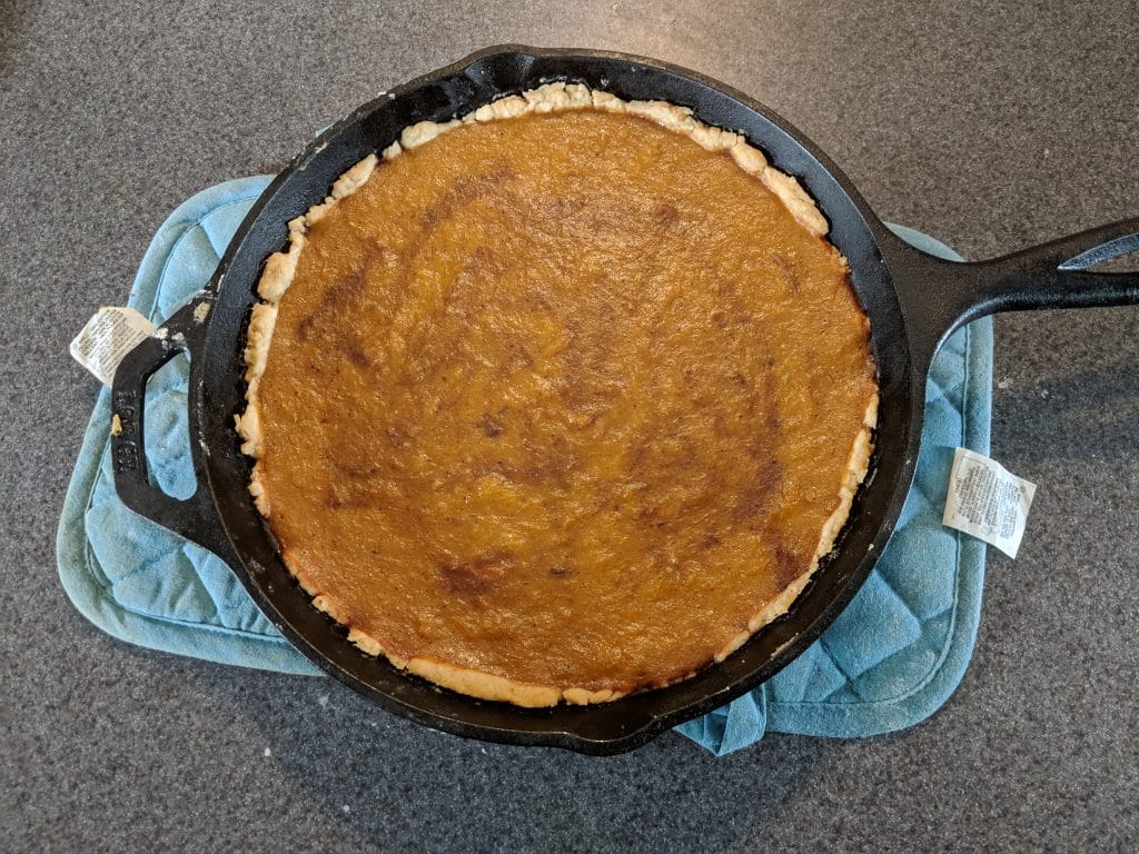 Finished pumpkin pie in a cast iron skillet.