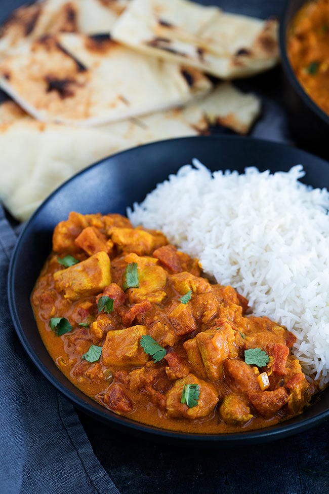Chicken tikka masala, a orange curry with chunks of chicken and tomato