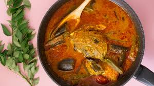 A soupy red curry with whole fish heads