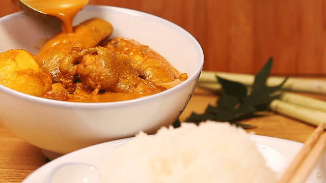 A bright yellow Singapore curry with a whole chicken worth of meat