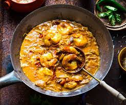 A bright orange Sri Lankan curry filled with prawns and mustard seed
