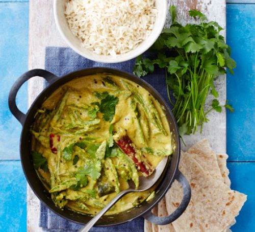 A bright green curry full of runner beans, coriander, and red chilies