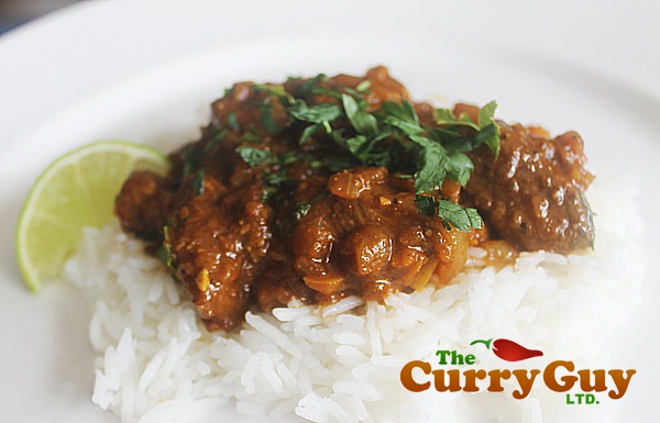 A bed of white rice, with a citrus flavored beef curry on top