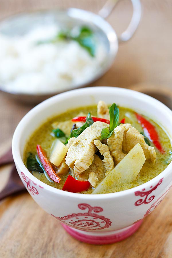 A Thai green curry, with slices of chicken, red bell pepper, Thai eggplant, and kaffir lime leaves
