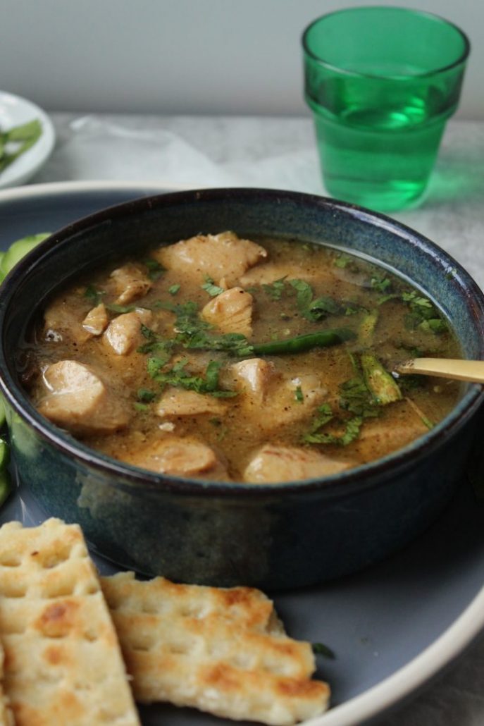 A brothy white chicken curry that resembles chicken soup