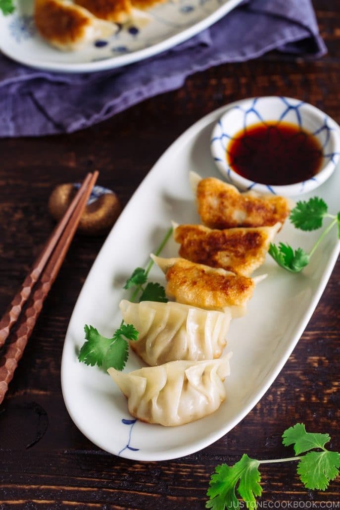 Crispy gyoza dumplings with a dipping sauce on the side