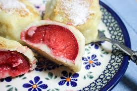 Round dumplings with plums inside and sugar on the outside
