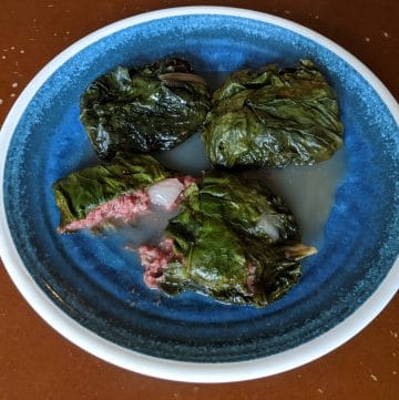 3 Palusami on a plate, with coconut cream on the bottom