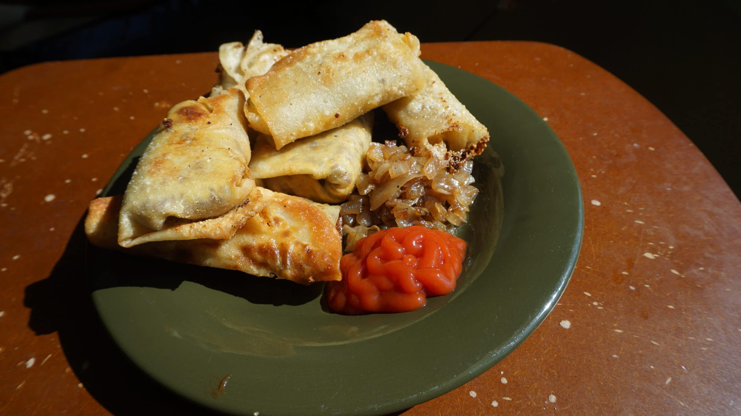 Cheeseburger Spring Rolls with ketchup and pickled onions