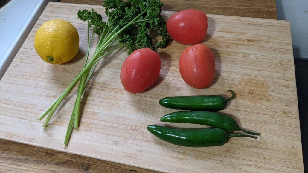 Chirmol ingredients including lemon, serrano peppers, roma tomatoes, and parsley.