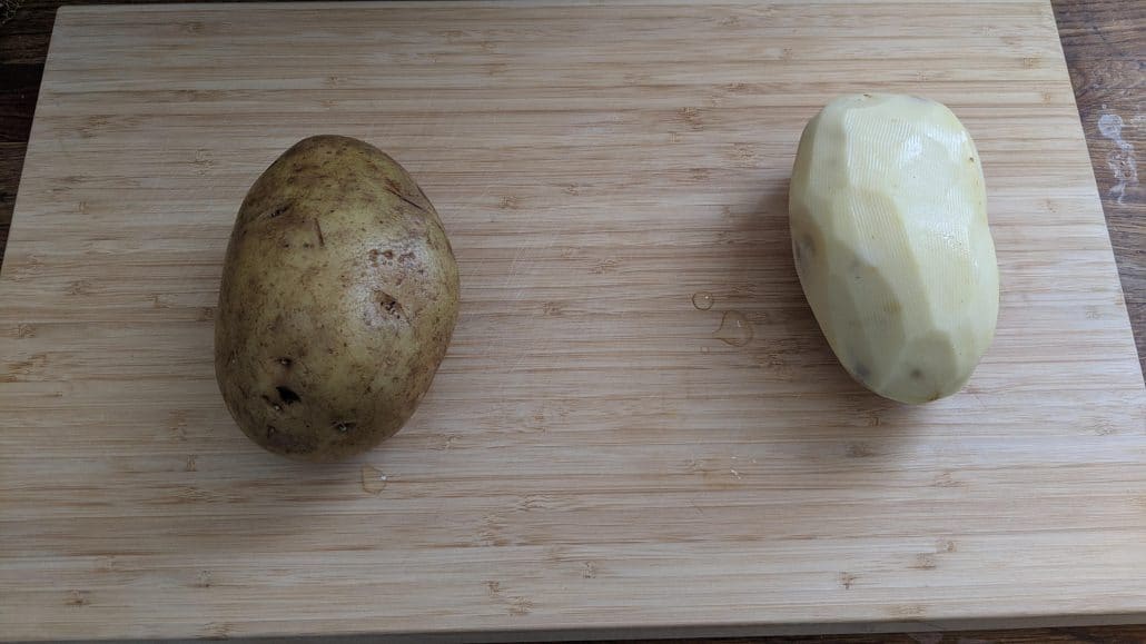 A peeled and unpeeled potato